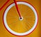 Fixed gear bicycle wheel with thin red tire and white wide rim