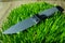 Fixed knife on grass. Cold teperature.