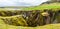 Fjadrargljufur canyon steep cliffs and waters of Fjadra river panorama, South Iceland