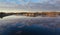 Fjords of Norway. Water in the fjords of Norway, stones on the shore, the sky is reflected in the water, clouds.