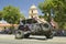 Flag adorned jeep demonstrates 4 wheel maneuvers as it makes its way down main street during a Fourth of July parade in Ojai, CA