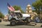 Flag adorned jeep demonstrates 4 wheel maneuvers as it makes its way down main street during a Fourth of July parade in Ojai, CA