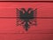 Flag of Albania on wooden wall background. Grunge Albanian flag texture.