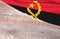 Flag Angola and space for text on a wooden background