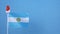 Flag of Argentina with little santa claus hat on blue background. New Year winter holiday concept, copy space