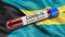 Flag of the Bahamas waving in the wind with a positive Covid-19 blood test tube. 3D illustration concept.