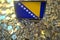 Flag of Bosnia and Herzegovina on the laptop screen and many bitcoins. National cryptocurrency regulations and crypto