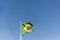 Flag of Brazil fluttering in the wind. In the center of the flag with the words \\\