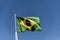 Flag of Brazil fluttering in the wind. In the center of the flag with the words \\\