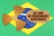 On the flag of Brazil, the symbol of radioactivity and torn cardboard with the inscription - As Low As Reasonably Achiev