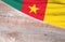 Flag Cameroon and space for text on a wooden background