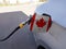 Flag of Canada on the car`s fuel tank filler flap. Petrol station. Fueling car at a gas station
