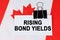 On the flag of Canada lies a business card with the inscription - rising bond yields
