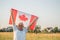 Flag of Canada, National symbol waving against, sunny day. Canada flag in senior man hand. selective focus