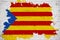 Flag of catalonia yellow, red stripe and star with watercolor splash effect on white brick wall background, national catalan symbo