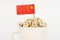 The flag of China sticks out of a cup with cubes on which letters are depicted