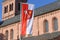 Flag with city arms of city `Worms` in Germany showing a white key and a five pointed yellow star on red background