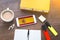 flag and coat of arms of spain, smartphone, wireless headphones, spanish textbook, notepad on a working wooden brown table