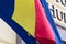 Flag of the European Union covered with the Romanian flag. Political relations and union concept. Close-up view.