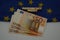 A flag of the European Union with written, recovery fund and some banknotes