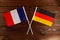 Flag of France and flag of Germany crossed with each other. The image illustrates the relationship between countries