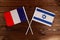 Flag of France and flag of Israel crossed with each other. The image illustrates the relationship between countries