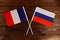 Flag of France and flag of Russia crossed with each other. The image illustrates the relationship between countries