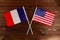 Flag of France and flag of USA crossed with each other. The image illustrates the relationship between countries