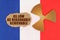 On the flag of France, the symbol of radioactivity and torn cardboard with the inscription As Low As Reasonably