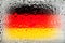 Flag of Germany. Germany flag on the background of water drops. Flag with raindrops. Splashes on glass