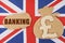 On the flag of Great Britain, a bag with a money symbol and a cardboard with the inscription - banking