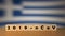 Flag of Greece with outbreak deadly coronavirus covid-19 in background. Wooden blocks with inscription 2019-nCov. Greece flag