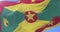 Flag of Grenada waving at wind in slow in blue sky, loop