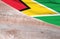 Flag Guyana and space for text on a wooden background