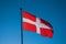 Flag of the Haute-Savoie region against light and with blue sky in the background.