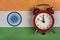 Flag of India and the old alarm clock. Traveling to India. Time to learning Indian