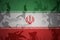 flag of iran on the khaki texture . military concept