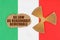 On the flag of Italy, the symbol of radioactivity and torn cardboard with the inscription As Low As Reasonably Achiev