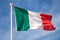 Flag of Italy waving on wind over sky