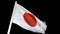 Flag of Japan with illumination on wind at night