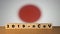 Flag of Japan with outbreak deadly coronavirus covid-19 in background. Wooden blocks with inscription 2019-nCov. Japan flag