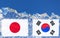 The flag of Japan and South Korea are painted at opposite end of piece of ice in the form of an arctic iceberg against blue sky.