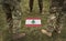 Flag of Lebanon and soldiers legs on the grass collage