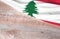 Flag Lebanon and space for text on a wooden background