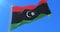 Flag of Libya waving at wind with blue sky in slow, loop