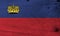 Flag of Liechtenstein on wooden plate background. Grunge Liechtensteiner flag texture.