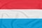 Flag of Luxembourg on textured fabric. Patriotic symbol
