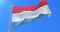 Flag of Luxembourg waving at wind with blue sky in slow, loop