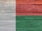 Flag of Madagascar on wooden wall background. Grunge Madagascar flag texture.
