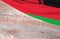 Flag Malawi and space for text on a wooden background